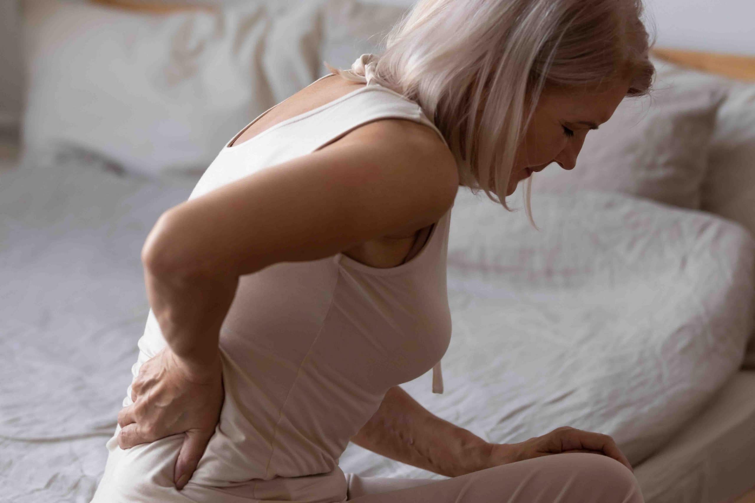Elderly lady has low back pain.