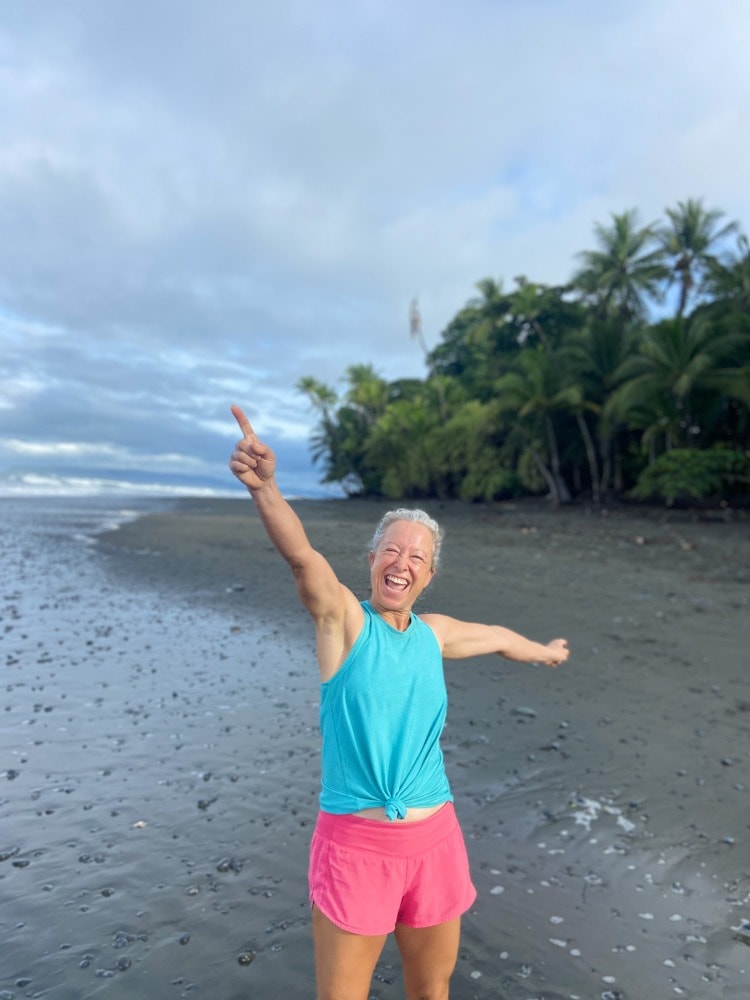 Woman cheering enthusiastically, representing the surprising relief and improvement in her low back pain.