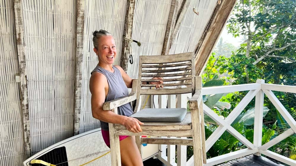 Woman is happily getting rid of furniture.