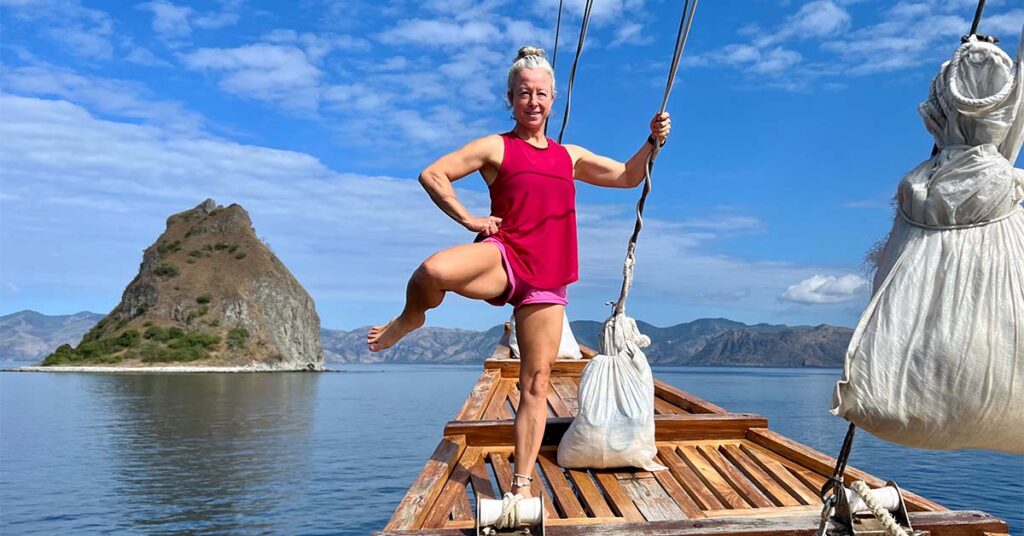 Woman doing controlled articular rotation to improve her joints mobility on a boat