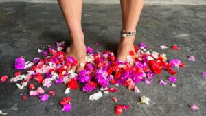Happy healthy feet surrounded by flower petals.