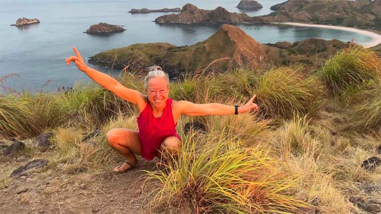 Woman is squatting in Padar Island, Indonesia.