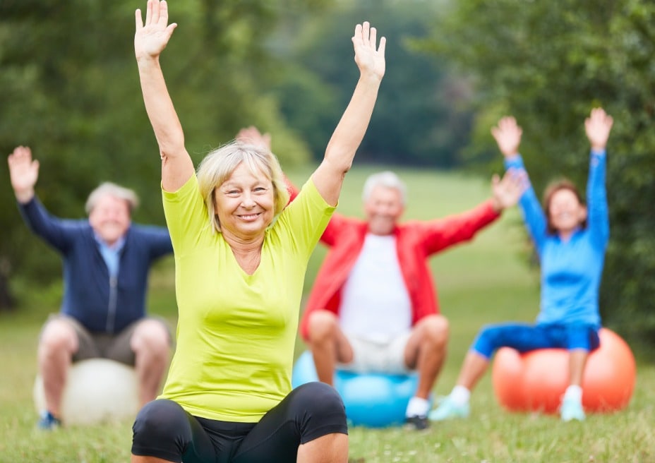 Elderly woman joyfully engaging in gentle movements.