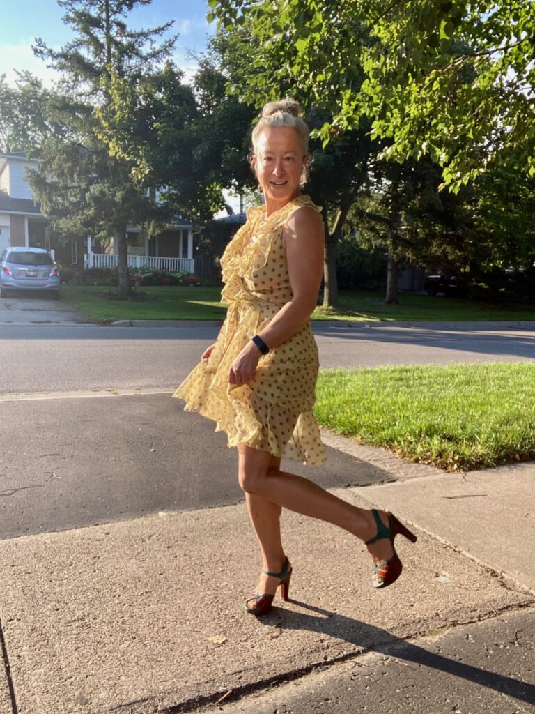 Woman twirling in dress and high heels